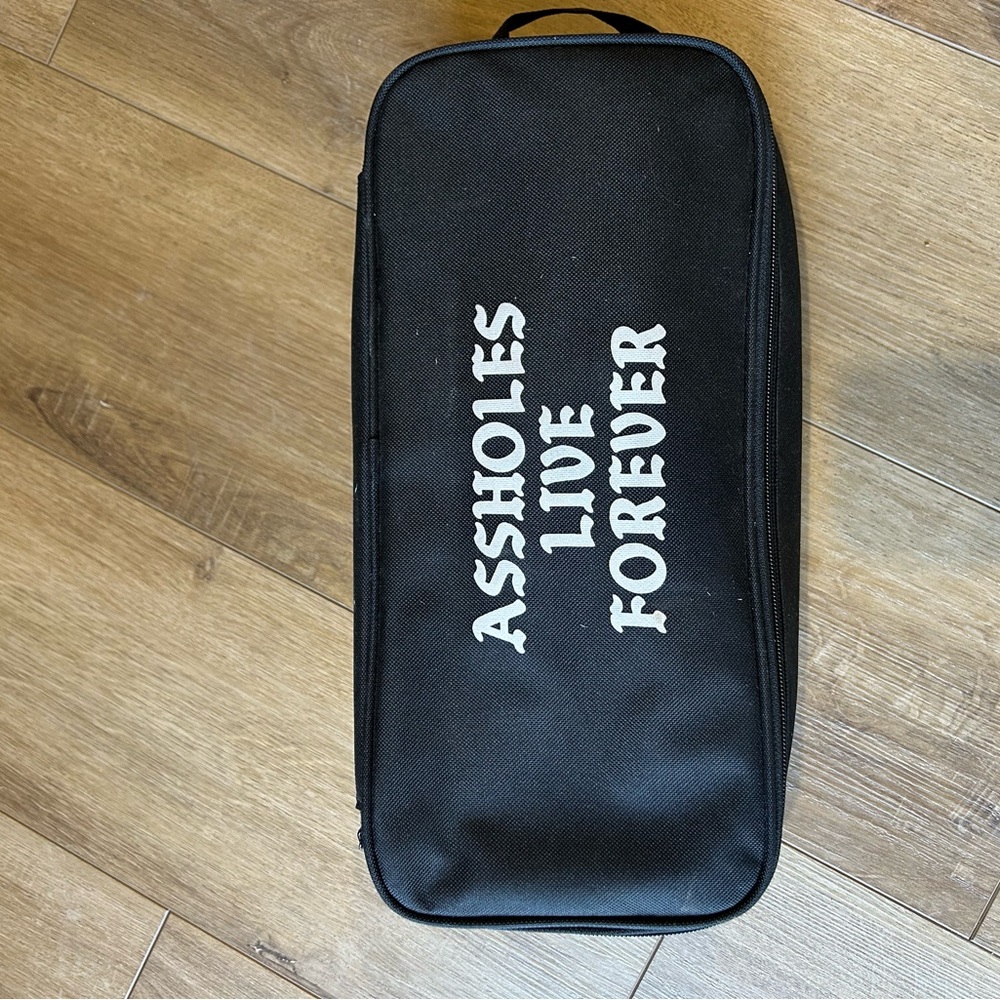Black Zippered Travel Pouch with White Slogan